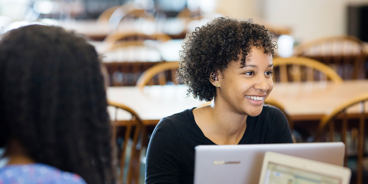 Student smiling with computer