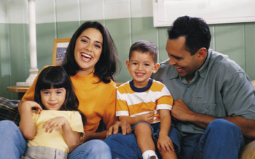 Image of family smiling and laughing
