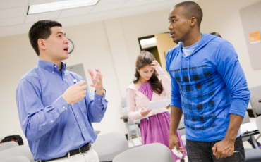 Image of a student speaking with a teacher