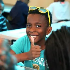 Freedom student giving a thumbs up to the camera