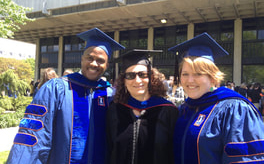 Image of faculty smiling at graduation