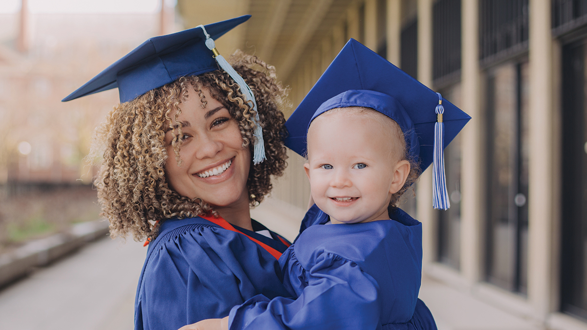 Image of graduating student with daughter both are wearing a cap and gown
