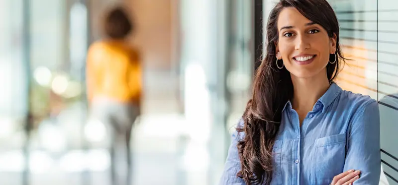 Female person smiling with arms crossed